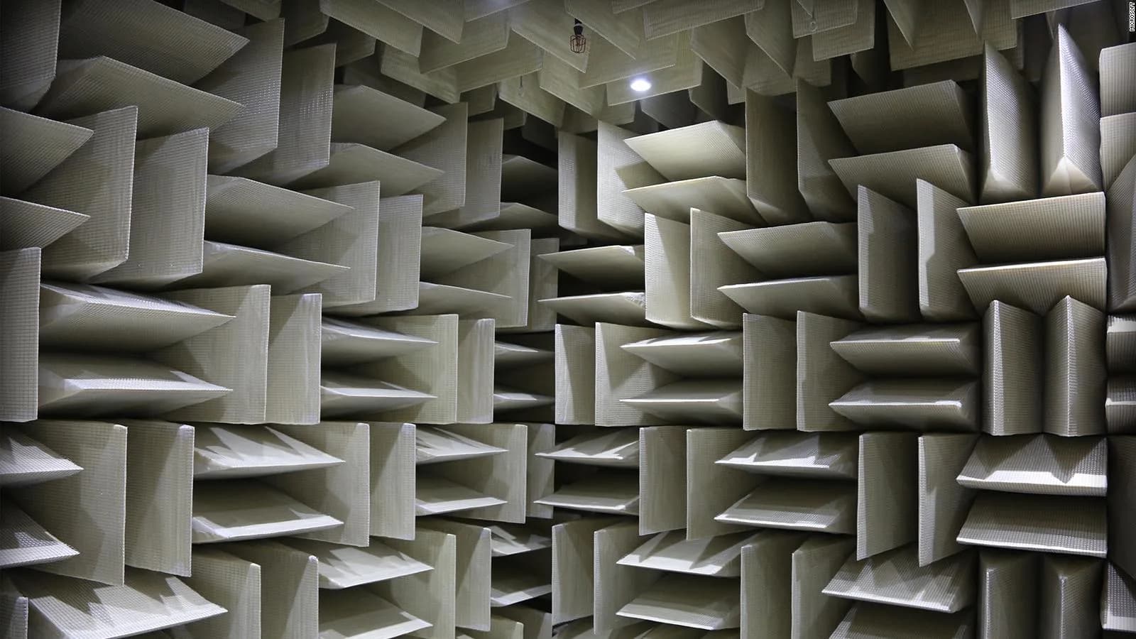 The wedge-lined wall of an anechoic chamber, the kind of space a free-field microphone comparison is made in